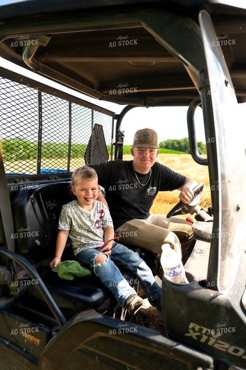 Farmer and Farm Kid in Side by Side 115826