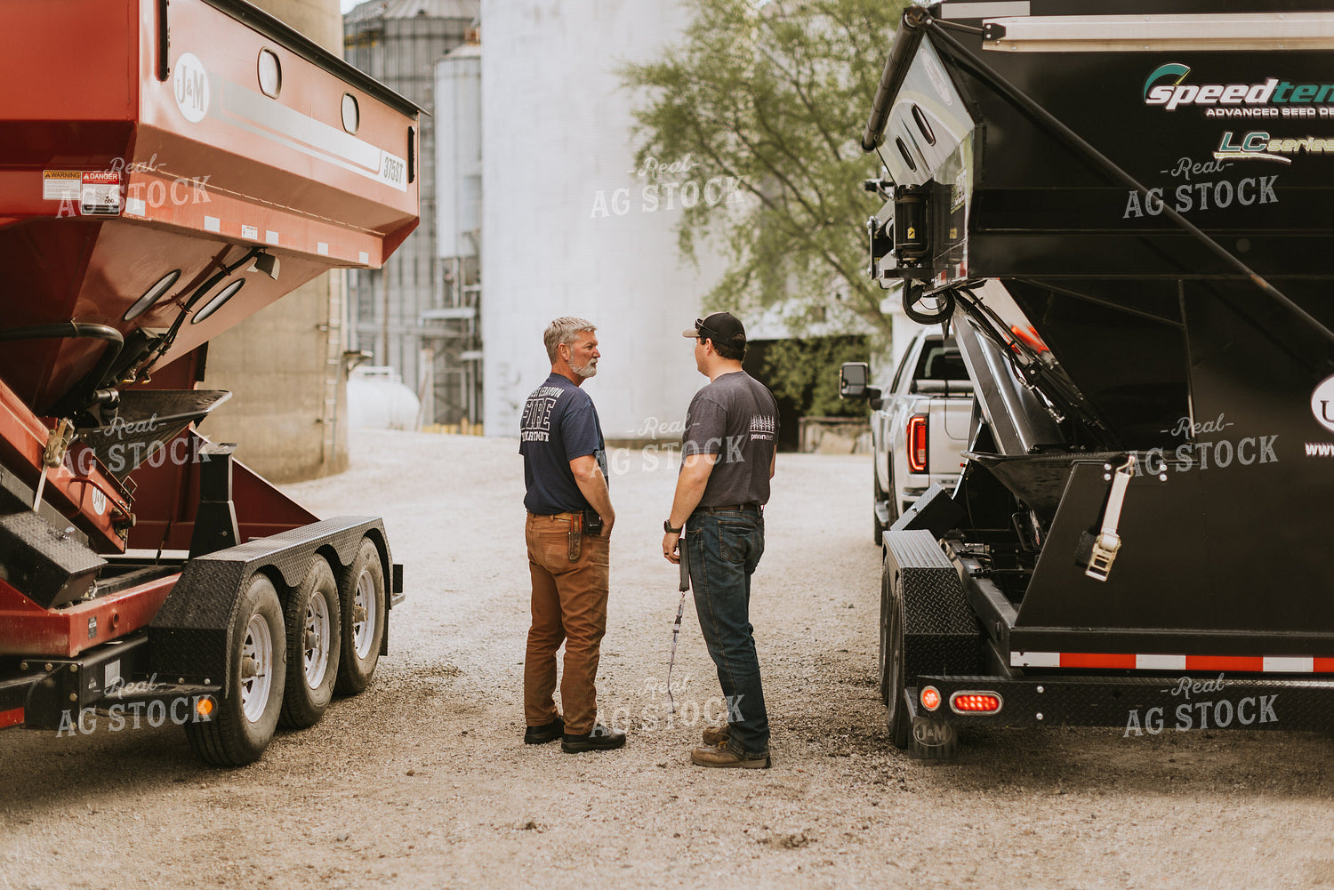 Farmers Talk in Front of Grain Bins 7596