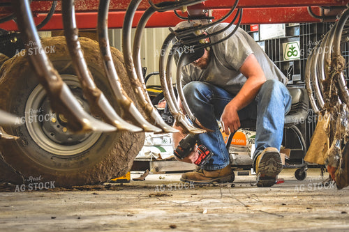 Farmer Working on Chisel Plow 56167