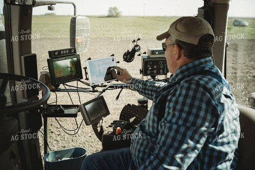 Farmer Adjusting Planter Monitor 4097