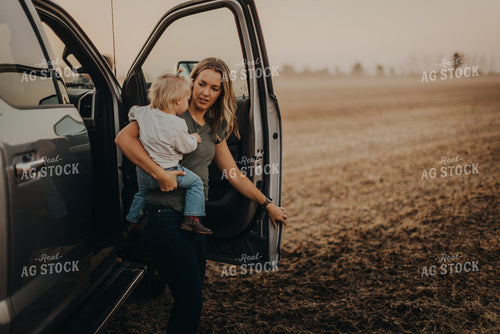 Farm Wife Holding Daugher in Field 9277
