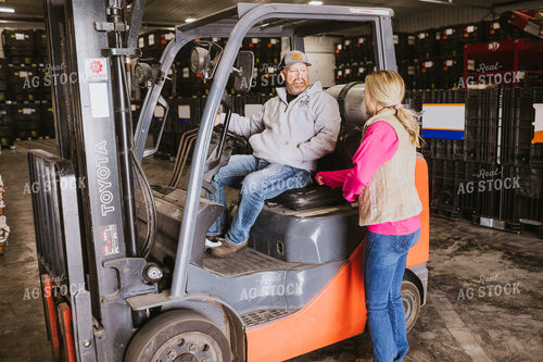 Forklift Operator Talking to Woman in Seed Warehouse 5346