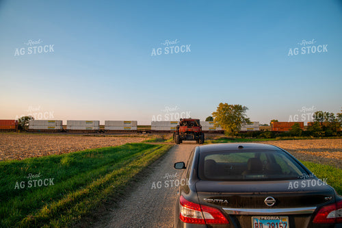 Combine Waiting for Train at Railroad Tracks 25450