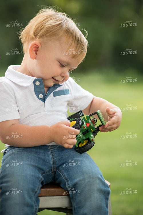 Farm Kid with Toy Tractor 76397
