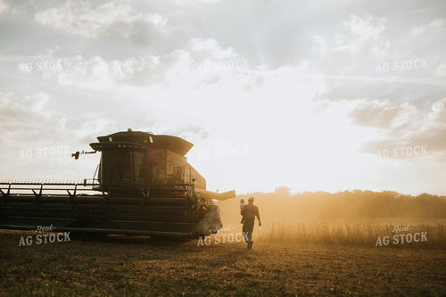 Farmer and Farm Kid Getting into Combine 4830