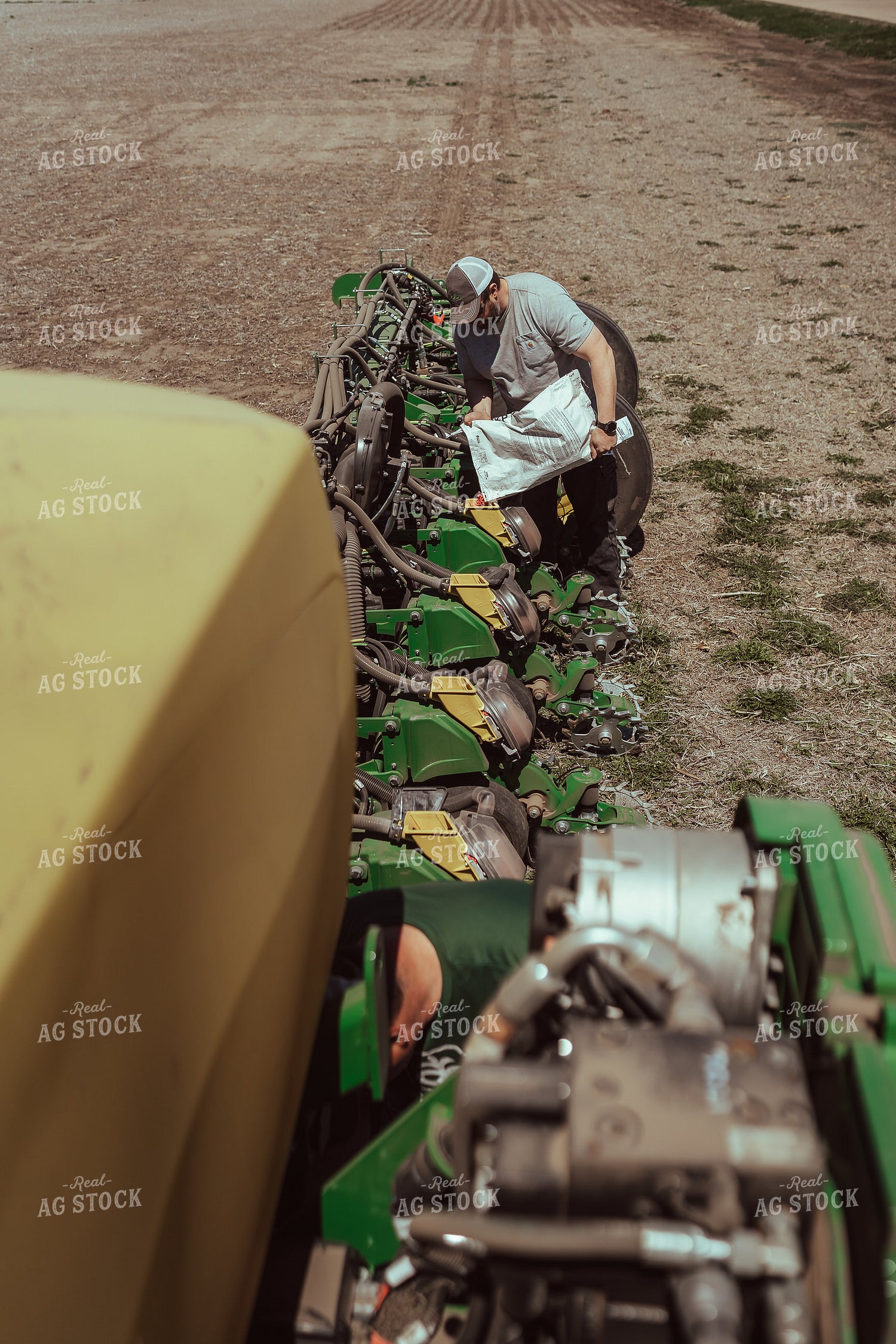 Farmer Filling Planter for Test Plot 196138