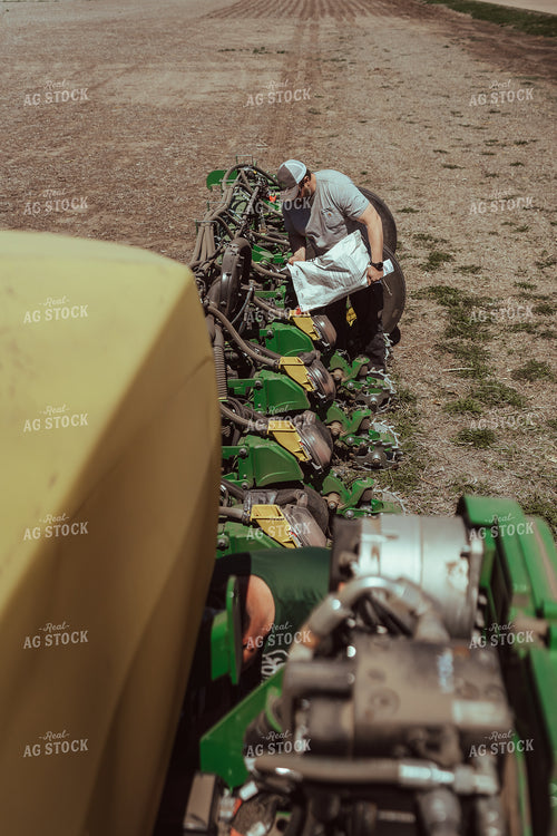 Farmer Filling Planter for Test Plot 196138