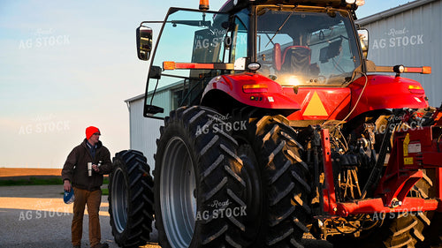 Farmer Climbing into Tractor Cab 25344