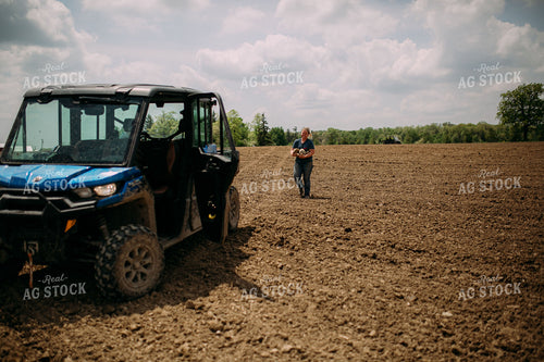 Female Farmer Picking Up Rocks 169096