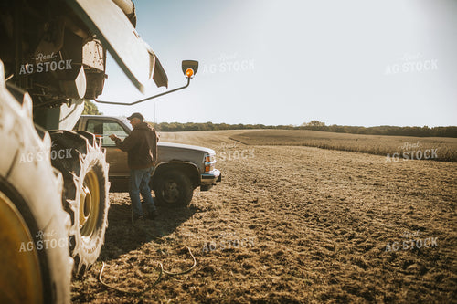 Farmer Using Air Hose to Clean Combine During Soybean Harvest 5199