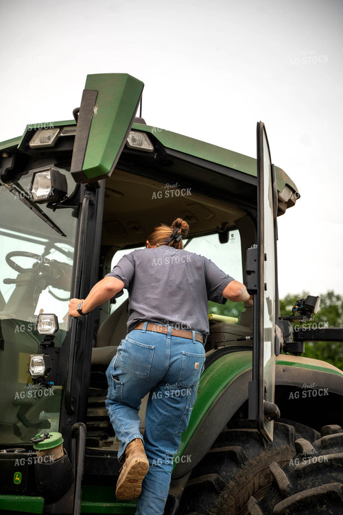 Female Farmer Climbing into Planter 115687