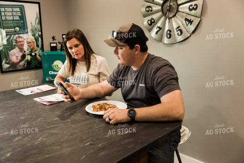Farmers Review Seed Orders While Eating Lunch in Farm Office 7613