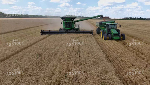 Aerial of Wheat Harvest Combine Loading Grain Cart 79219