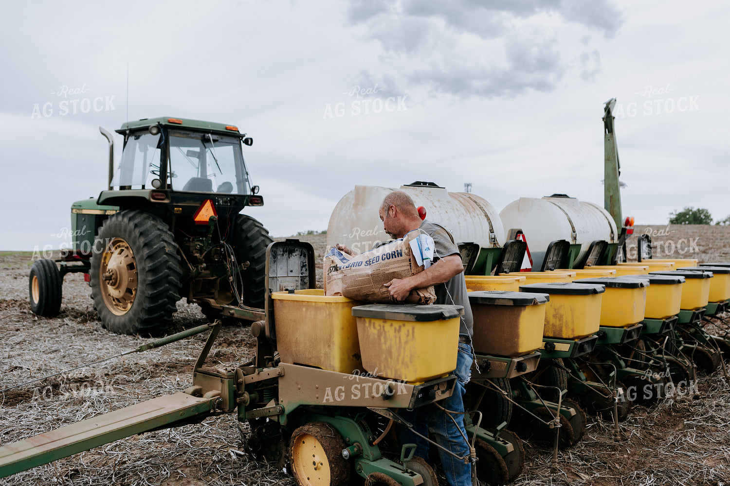 Farmer Filling Planter Boxes 77069