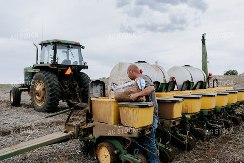 Farmer Filling Planter Boxes 77069