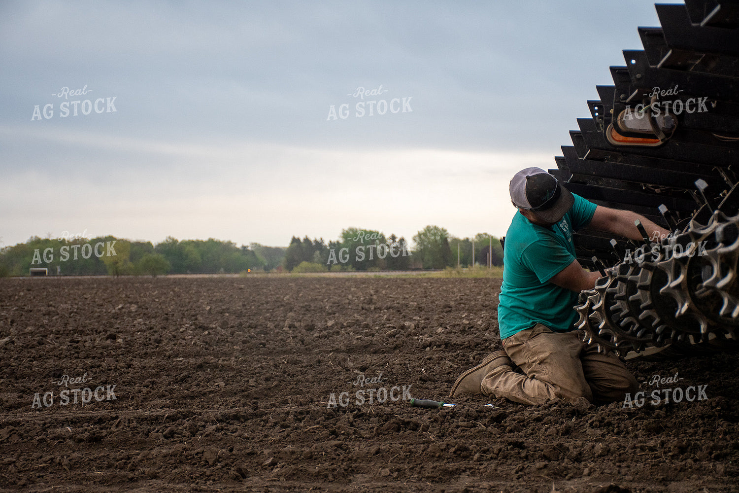 Farmer Working on Equipment 50278