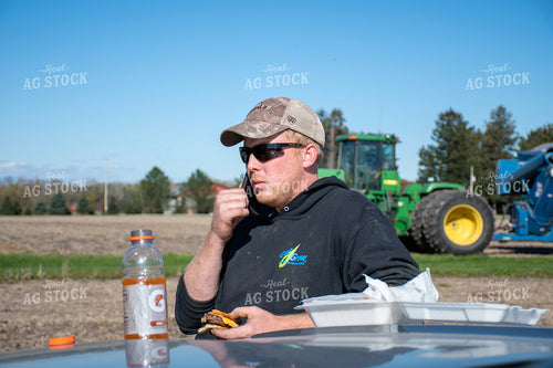 Farmer on Phone Eating Lunch 50193
