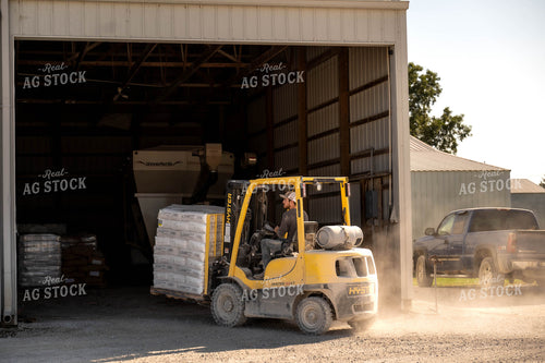 Farmer Carrying Bags on Skid Steer 115525
