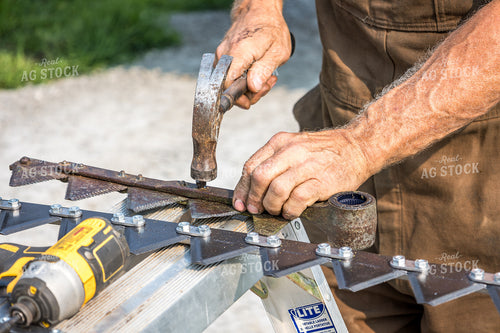 Farmer Fixing Swather 138093