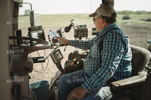 Farmer Adjusting Planter Monitor 4288