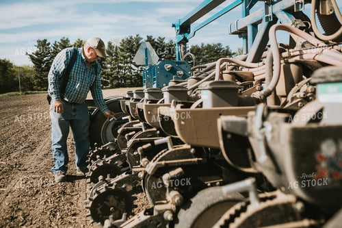 Farmer Adjusting Planter 4128
