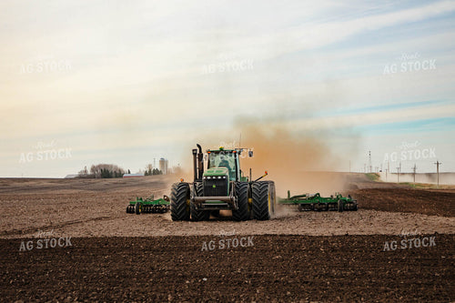Large Tractor Plowing Field on a Dusty Spring Day 152474