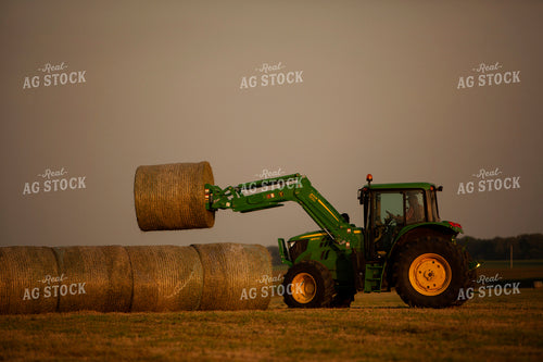 Tractor Lifting Round Hay Bale Overcast Sky 5525
