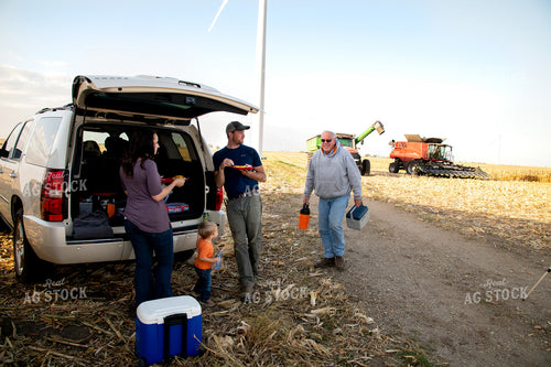 Family Enjoying Harvest Meal in the Field 25813