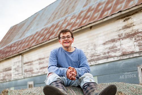 Farm Kid Climbing on Hay Bale 155578