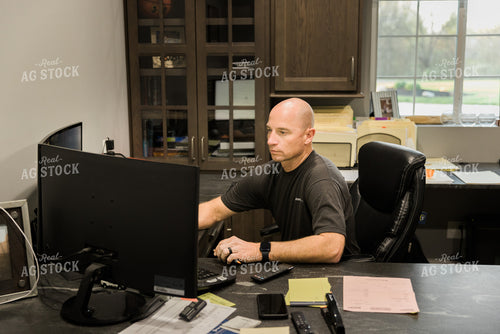 Farmer Works on Computer in Office 7491