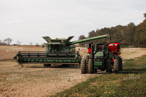 Combine Emptying Soybeans into Grain Cart 52252