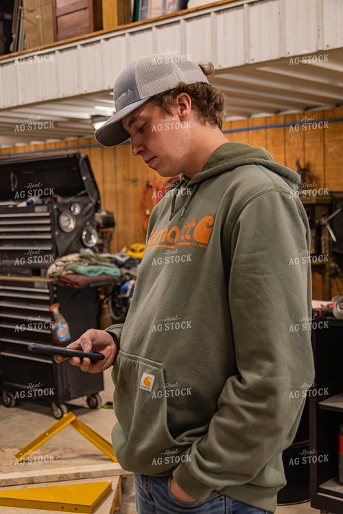 Farmer Using Phone in Shop 231120