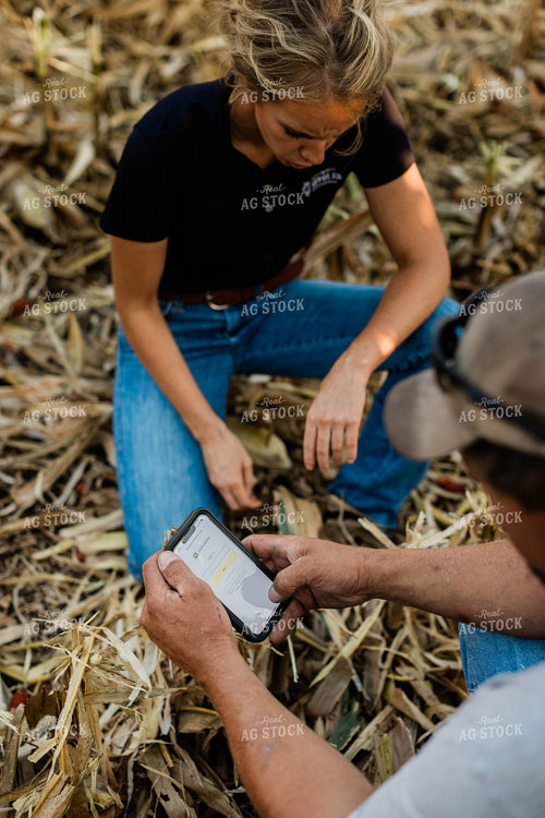 Farmer and Agronomist Using Phone in Field 8291