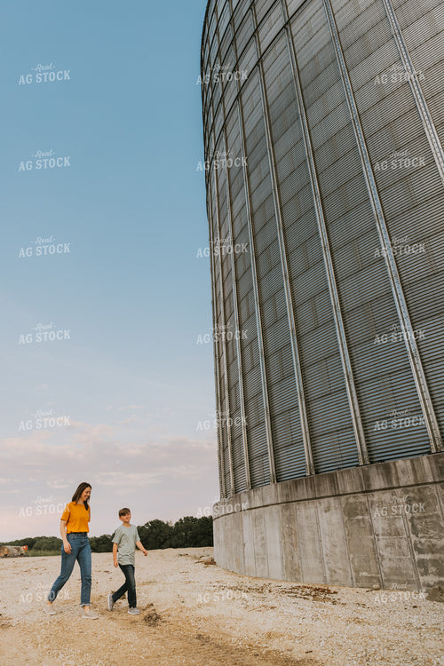Farm Wife and Son Walk by Grain Bin 7801