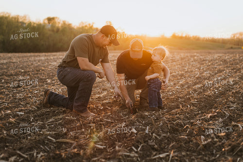Young Farmers with Child Check Seed Depth After Planting 7713
