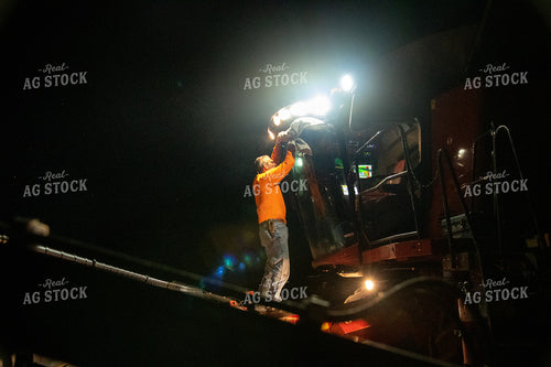Farmer Sitting in Combine at Night 25805