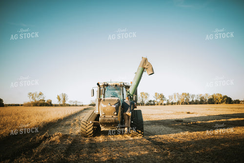 Farmer Climbing into Auger Wagon 5073
