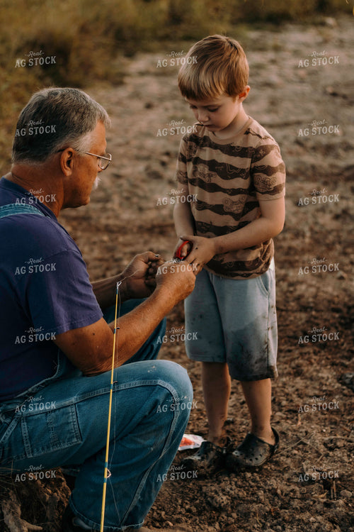 Farmer and Farm Kid Working on Fishing Pole 108047