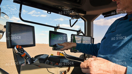Farmer in the Tractor Cab with Technology 25233