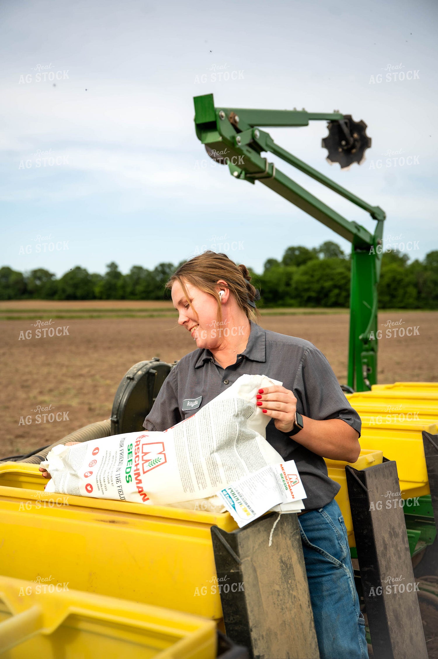 Female Farmer Filling Planter 115631