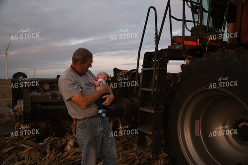 Farmer Holding Kid in Field 26039