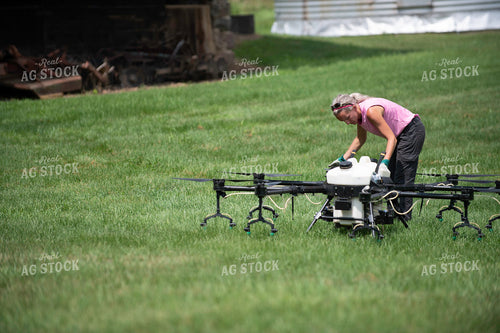 Female Pilot Preparing Drone for Fungicide Application 168072