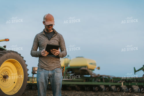 Farmer using Tablet in Field by Planter 8255