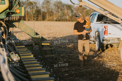 Young Farmer with Child Walks Along Planter 7702
