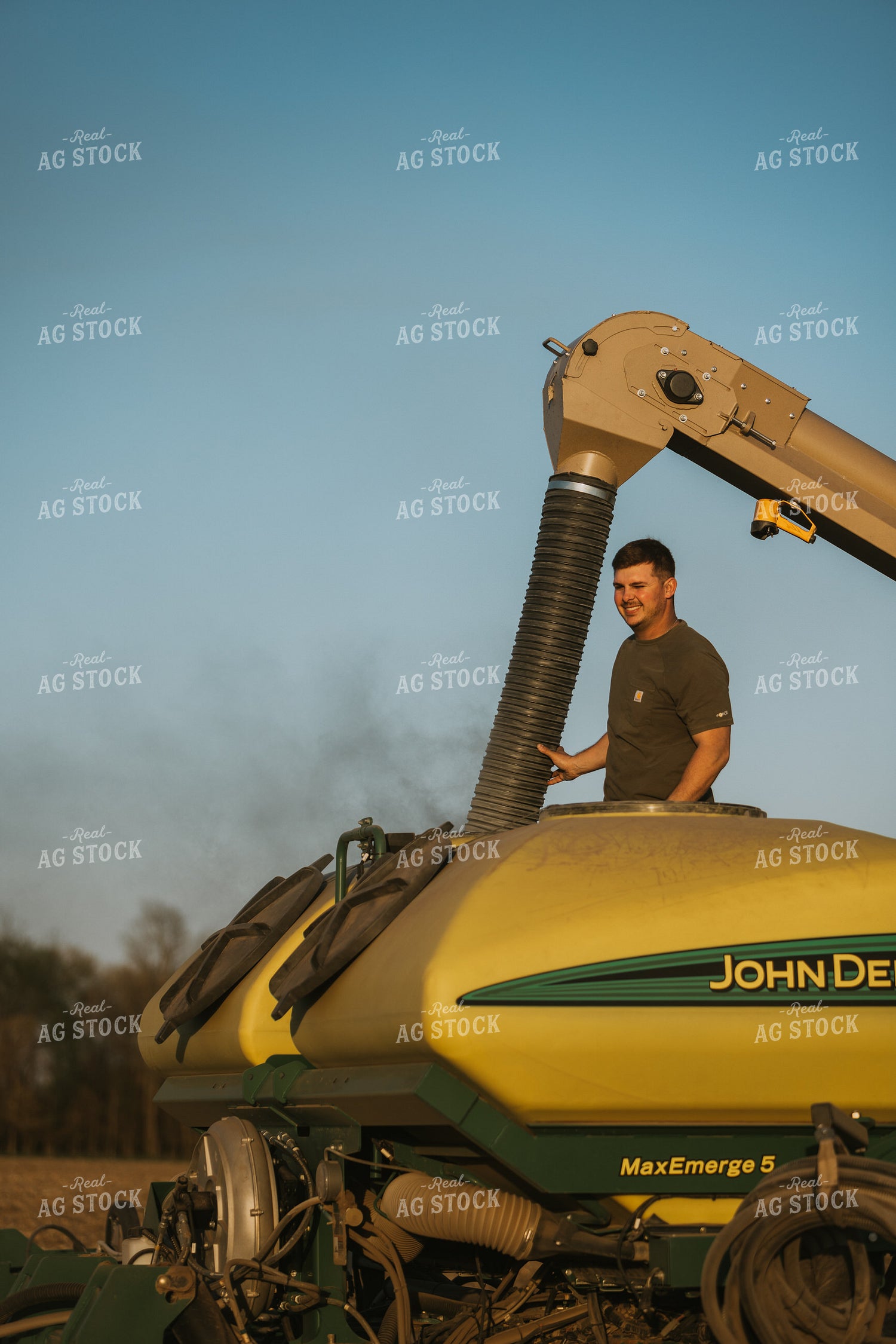 Farmer Fills Planter with Seed Tender in Field 7701