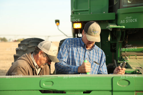 Farmers Fixing Combine 114106
