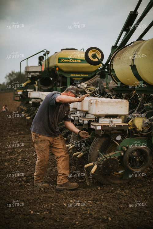 Farmer Adjusting Planter 5692