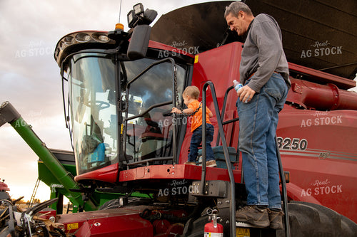 Grandson and Grandfather Farmer Climbing onto Combine 25832