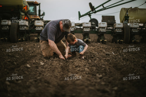 Farmer and Farm Kid Checking Seed Depth 5654