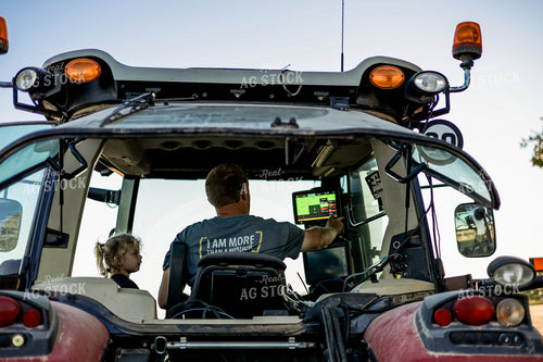 Farmer and Farm Kid Setting Up Monitor 93341